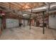 Spacious basement featuring garage doors and industrial-style ceiling at 92 Confidence Ct, Temple, GA 30179