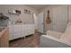 Cozy Bedroom with a comfortable chair, white dresser, stylish decor, and neutral walls, creating a serene environment at 92 Confidence Ct, Temple, GA 30179