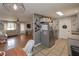 Efficient kitchen open to the living room with stainless steel appliances and tile floor at 92 Confidence Ct, Temple, GA 30179