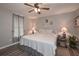 Comfortable bedroom with a ceiling fan, neutral walls, stylish decor, and warm lamps for a cozy atmosphere at 92 Confidence Ct, Temple, GA 30179