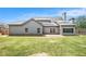 View of backyard featuring home exterior, solar panels, and privacy fence at 101 Ruby Lane, Mcdonough, GA 30252