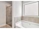 Close up of a soaking tub, featuring tile backsplash and glass enclosed shower at 101 Ruby Lane, Mcdonough, GA 30252