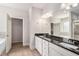 Bathroom featuring double sinks with a large mirror, and a walk in closet at 101 Ruby Lane, Mcdonough, GA 30252