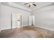 Spacious bedroom featuring a ceiling fan and doors leading to a bathroom at 101 Ruby Lane, Mcdonough, GA 30252
