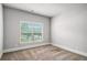 Carpeted bedroom with ample natural light from a large window at 101 Ruby Lane, Mcdonough, GA 30252
