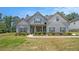 Charming two-story home with light blue siding, gray shutters, and well-manicured landscaping at 101 Ruby Lane, Mcdonough, GA 30252