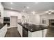 Modern kitchen with black countertops, white cabinets, stainless steel appliances and pendant lighting at 101 Ruby Lane, Mcdonough, GA 30252