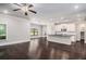 Open-concept living room with hardwood floors, white trim, and a view of the kitchen at 101 Ruby Lane, Mcdonough, GA 30252