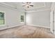 Spacious main bedroom with tray ceilings, neutral carpet, and two large windows at 101 Ruby Lane, Mcdonough, GA 30252