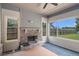 Relaxing sunroom with a stone fireplace, ceiling fan, and oversized windows overlooking backyard at 101 Ruby Lane, Mcdonough, GA 30252