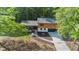 Aerial view of a two-story home showcasing driveway, yard, and surrounding trees at 1129 Pinehurst Rd, Grayson, GA 30017