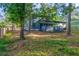 Picture of backyard with mature trees, screened in porch and privacy fence at 1129 Pinehurst Rd, Grayson, GA 30017