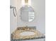 Bathroom sink has granite countertop, gold faucet and round mirror with vanity lighting at 1129 Pinehurst Rd, Grayson, GA 30017