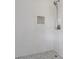 Close up of tiled shower with hexagon floor tile and mosaic accent tile and chrome shower head at 1129 Pinehurst Rd, Grayson, GA 30017