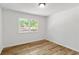 Bedroom with wood-look flooring and window at 1129 Pinehurst Rd, Grayson, GA 30017