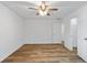 Bedroom featuring wood-look flooring, white walls, and doorway to closet at 1129 Pinehurst Rd, Grayson, GA 30017