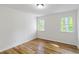 Bedroom with wood-look flooring and two windows at 1129 Pinehurst Rd, Grayson, GA 30017