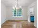 A bright dining area featuring hardwood floors, modern chandelier, and view of outdoors at 1129 Pinehurst Rd, Grayson, GA 30017