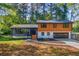 A charming two-story home featuring a two-car garage and gray and wood-paneled facade at 1129 Pinehurst Rd, Grayson, GA 30017
