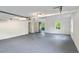 This large garage has a sealed floor, overhead lighting, and an entry/exit door at 1129 Pinehurst Rd, Grayson, GA 30017