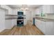 A newly renovated kitchen with granite countertops, modern appliances, and hardwood floors at 1129 Pinehurst Rd, Grayson, GA 30017
