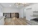 Open concept kitchen features white cabinets, granite countertops, stainless steel appliances, and hardwood floors at 1129 Pinehurst Rd, Grayson, GA 30017