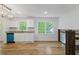 Bright kitchen features white cabinets, granite countertops, stainless steel sink, and hardwood floors at 1129 Pinehurst Rd, Grayson, GA 30017