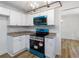 Beautiful kitchen features white cabinets, granite countertops, stainless steel appliances, and hardwood floors at 1129 Pinehurst Rd, Grayson, GA 30017