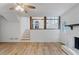 Open concept living room features hardwood floors, a fireplace, and a view of the kitchen at 1129 Pinehurst Rd, Grayson, GA 30017