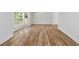 A bright, open living area featuring hardwood floors, white walls, and large bay window at 1129 Pinehurst Rd, Grayson, GA 30017