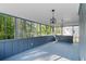 Covered porch has a wood floor, tongue and groove ceiling, with black iron light fixtures at 1129 Pinehurst Rd, Grayson, GA 30017