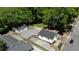 An aerial perspective of a house and detached garage, highlighting the new fence and tree coverage at 130 South Se Ave, Marietta, GA 30060
