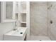 Modern bathroom featuring a sleek sink, stylish faucet, and a tiled shower at 130 South Se Ave, Marietta, GA 30060
