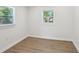 Light-filled bedroom featuring wood-look flooring and two windows providing natural light at 130 South Se Ave, Marietta, GA 30060