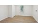 Neat bedroom with wood-look flooring, a window, and a closet at 130 South Se Ave, Marietta, GA 30060