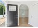 View of the home's light and airy entryway featuring an archway and durable wood-look flooring at 130 South Se Ave, Marietta, GA 30060