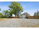 Exterior view of a house with a spacious gravel yard and wooden fence under a clear sky at 130 South Se Ave, Marietta, GA 30060