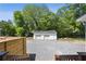 Exterior view of a detached garage with a spacious gravel yard and wooden fence at 130 South Se Ave, Marietta, GA 30060