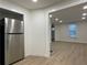 Stainless steel refrigerator in a kitchen with an opening that leads to a brightly lit living area at 130 South Se Ave, Marietta, GA 30060