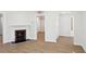Spacious living area showcasing wood-look flooring and a cozy fireplace, enhanced by neutral wall paint at 130 South Se Ave, Marietta, GA 30060