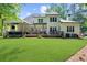 Expansive backyard shows a large manicured lawn, deck and the home's exterior at 1358 Peppergrass Nw Trl, Acworth, GA 30101