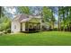 Spacious backyard features a lush green lawn, mature trees, and large wooden deck at 1358 Peppergrass Nw Trl, Acworth, GA 30101