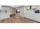 View of a finished basement featuring wood flooring, white cabinets, and open floor plan at 1358 Peppergrass Nw Trl, Acworth, GA 30101