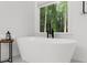 Beautiful bathroom featuring a luxurious soaking tub with backyard view at 1358 Peppergrass Nw Trl, Acworth, GA 30101