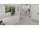 Beautiful bathroom featuring a soaking tub with backyard view and a luxurious glass shower at 1358 Peppergrass Nw Trl, Acworth, GA 30101