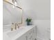 Elegant bathroom with white marble countertops, gold fixtures, and a classic design at 1358 Peppergrass Nw Trl, Acworth, GA 30101