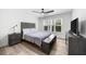Bright bedroom features natural light, modern ceiling fan, and wood-look flooring at 1358 Peppergrass Nw Trl, Acworth, GA 30101
