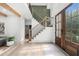 Elegant entryway with stairs, wood floors, and a stylish front door with lots of natural light at 1358 Peppergrass Nw Trl, Acworth, GA 30101