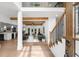 Bright foyer showcasing hardwood floors, stairs, beams and an open concept design to the living spaces at 1358 Peppergrass Nw Trl, Acworth, GA 30101