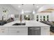 Bright kitchen features large island with sink, stainless steel appliances and modern hardware at 1358 Peppergrass Nw Trl, Acworth, GA 30101